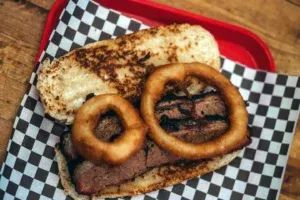 Onion Rings On Smoked Brisket Sandwich 1 — Roger That Bbq © 2024 Rogerthat.com © 2025